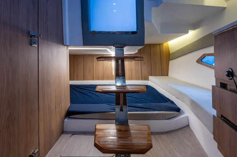 Xuru Yacht Photos Pics 2023 NX 340 yacht interior with wooden steps, modern design, and cozy sleeping area.
