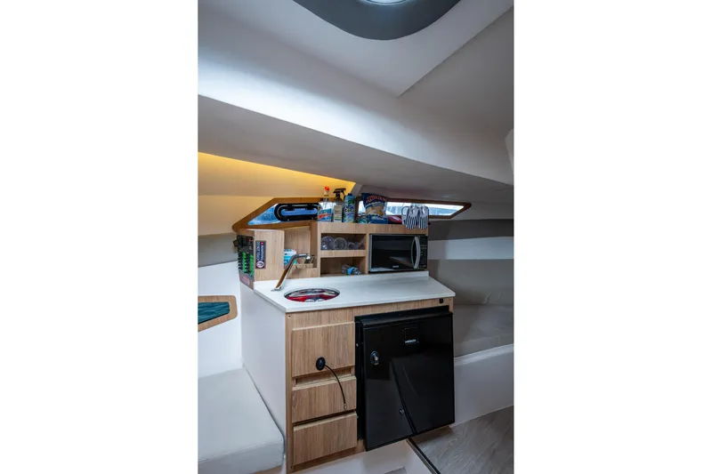 Xuru Yacht Photos Pics Compact kitchenette in 2023 NX 340 boat with microwave and mini fridge.
