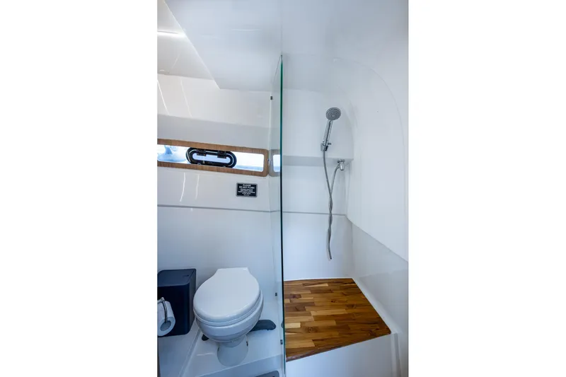 Xuru Yacht Photos Pics Modern bathroom in 2023 NX 340, featuring shower and toilet with wooden accents.