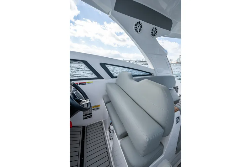 Xuru Yacht Photos Pics 2023 NX 340 boat interior with gray seating and steering wheel, overlooking the ocean.