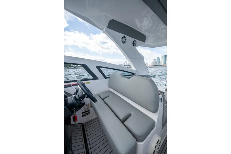 Xuru Yacht Photos Pics Interior of 2023 NX 340 boat with gray seating and city skyline view.