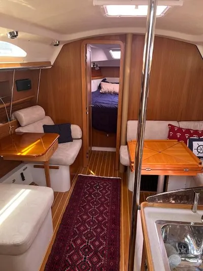 Rita Gale Yacht Photos Pics Interior of a 2012 Catalina 355 sailboat with cozy seating and wooden finishes.