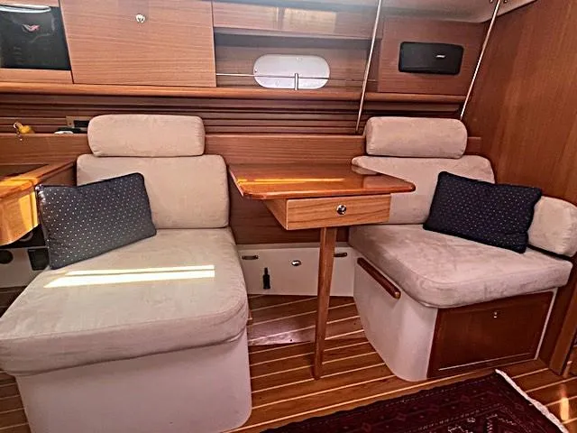 Rita Gale Yacht Photos Pics Interior of 2012 Catalina 355 sailboat with cozy seating and wooden table.