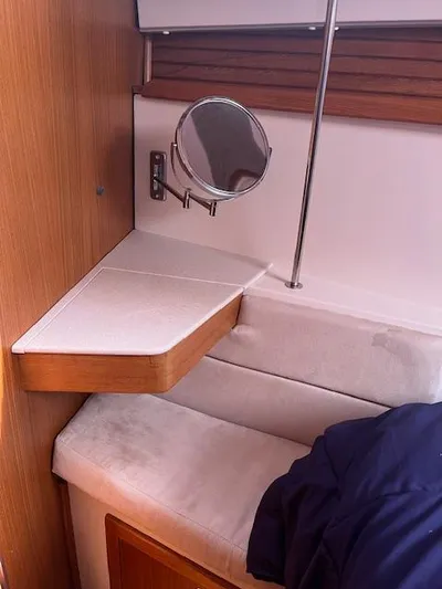 Rita Gale Yacht Photos Pics Interior of a 2012 Catalina 355 sailboat with a small shelf and mirror.