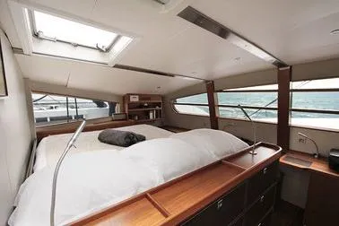 Vitalia II Yacht Photos Pics Luxurious interior of 2003 Multiplast High Performance Catamaran with spacious bed and ocean view.