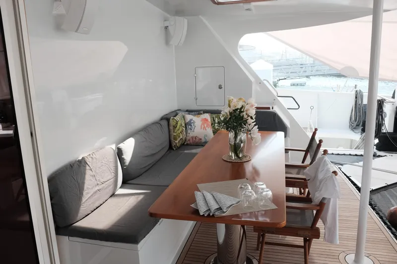 Vitalia II Yacht Photos Pics Luxurious 2003 Multiplast catamaran deck with elegant seating and dining area.