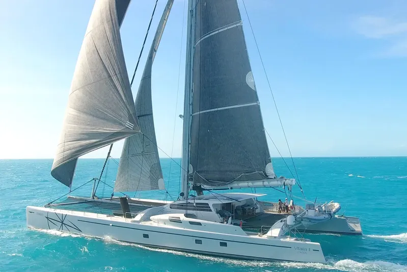 Vitalia II Yacht Photos Pics High-performance Multiplast catamaran sailing on turquoise waters, 2003 model.