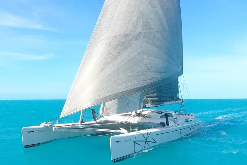 Vitalia II Yacht Photos Pics 2003 Multiplast High Performance Catamaran sailing on clear blue ocean waters.