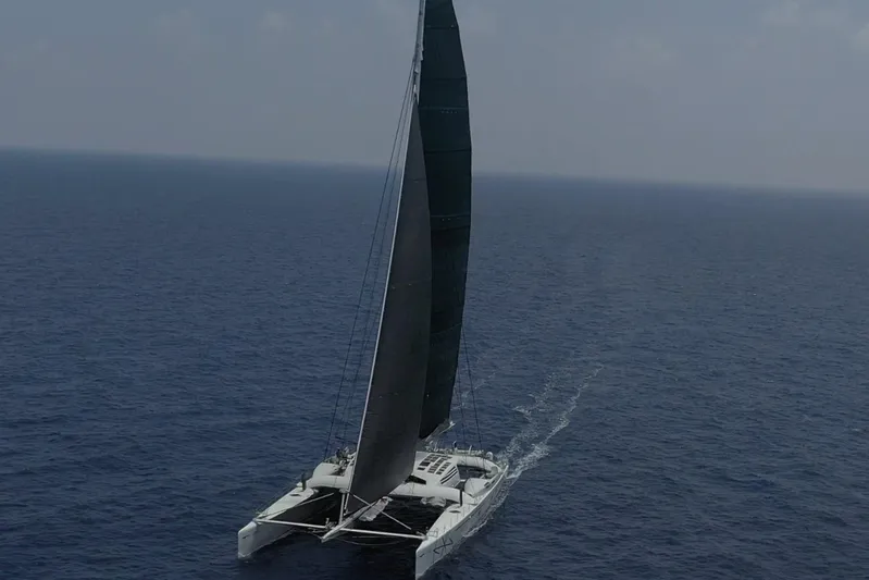 Vitalia II Yacht Photos Pics High-performance Multiplast catamaran sailing on open sea, 2003 model.