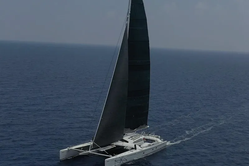 Vitalia II Yacht Photos Pics High-performance Multiplast catamaran sailing on open sea, 2003 model.