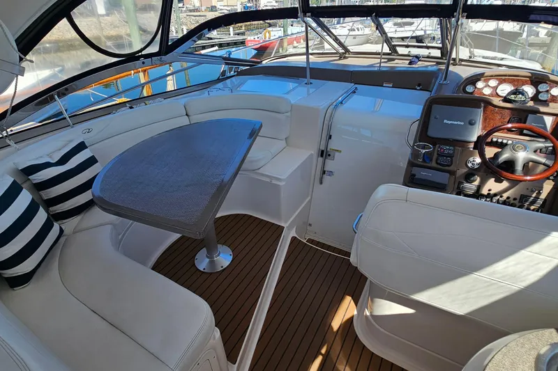  Yacht Photos Pics Luxurious 2005 Regal Commodore 4260 yacht interior with seating, table, and helm.
