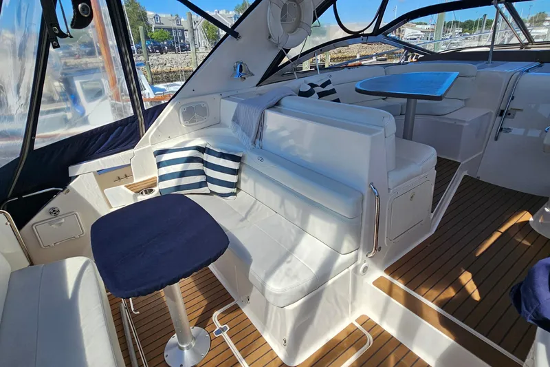  Yacht Photos Pics Luxurious 2005 Regal Commodore 4260 yacht interior with white seating and striped cushions.