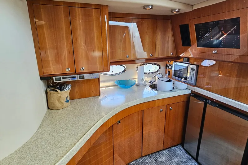  Yacht Photos Pics Luxurious 2005 Regal Commodore 4260 yacht kitchen with wood cabinets and modern appliances.
