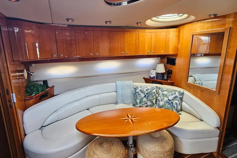  Yacht Photos Pics Luxurious interior of 2005 Regal Commodore 4260 yacht with elegant seating and wooden cabinetry.