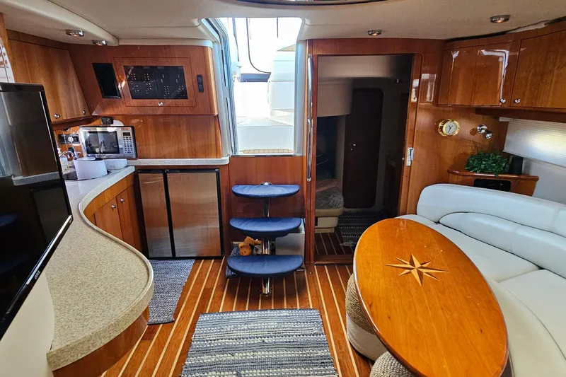  Yacht Photos Pics Luxurious interior of 2005 Regal Commodore 4260 yacht with wood finishes and modern amenities.