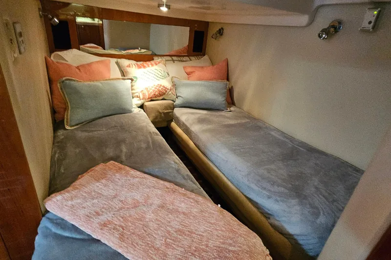  Yacht Photos Pics Cozy cabin interior of 2005 Regal Commodore 4260 with twin beds and decorative pillows.