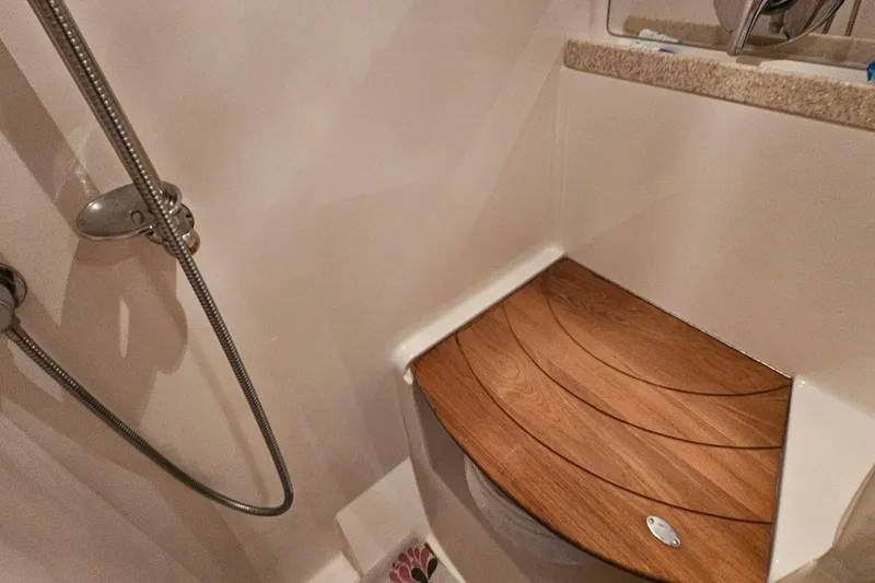  Yacht Photos Pics Shower area in 2005 Regal Commodore 4260 yacht with wooden seat and handheld showerhead.