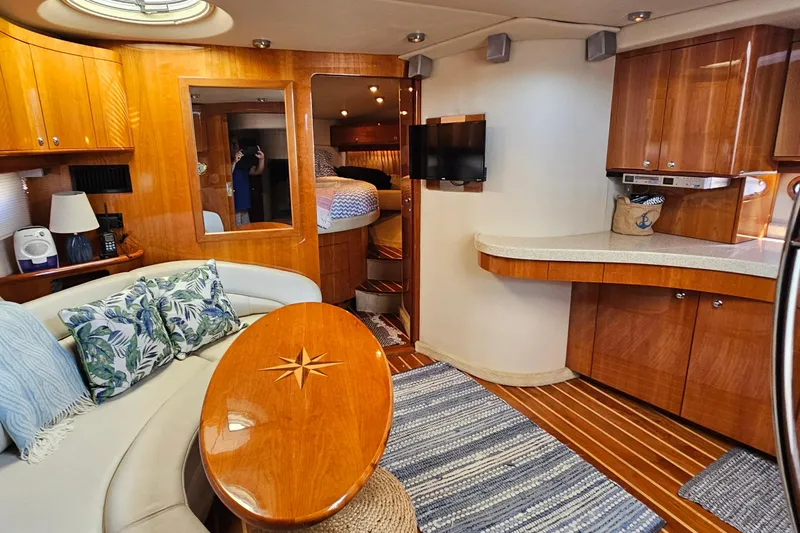  Yacht Photos Pics Luxurious 2005 Regal Commodore 4260 yacht interior with elegant wood finishes and cozy seating.