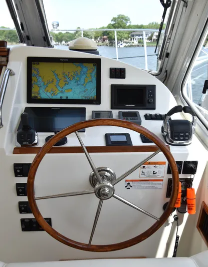 Delilah Yacht Photos Pics Helm of 2011 MJM 40z Downeast boat with navigation equipment and wooden steering wheel.