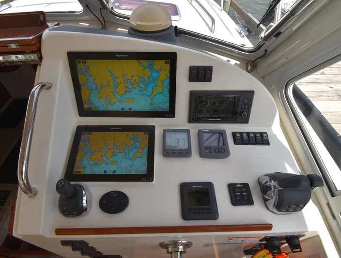 Delilah Yacht Photos Pics Control panel of a 2011 MJM 40z Downeast boat with navigation screens.