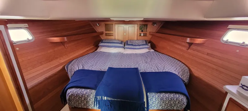 Delilah Yacht Photos Pics 2011 MJM 40z Downeast boat cabin with cozy bed and wooden interior.