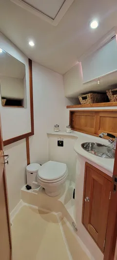 Delilah Yacht Photos Pics 2011 MJM 40z Downeast yacht bathroom with modern fixtures and wooden cabinetry.