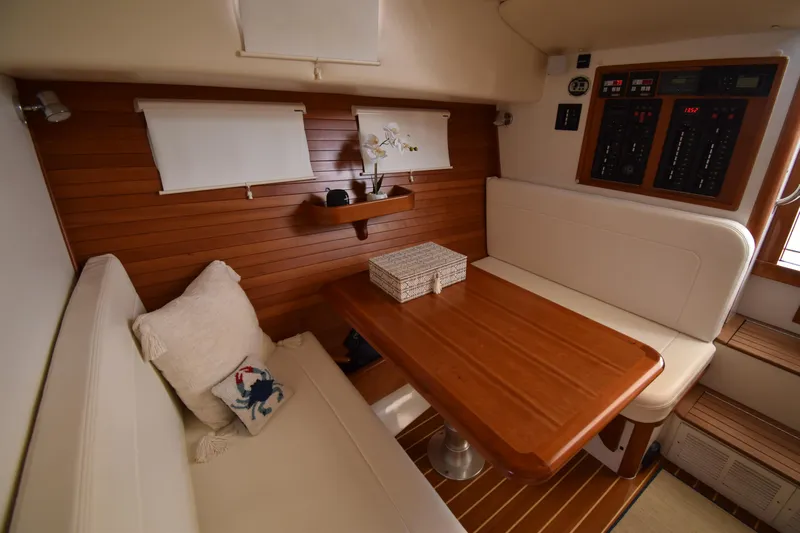 Delilah Yacht Photos Pics 2011 MJM 40z Downeast yacht interior with wooden table and white seating.