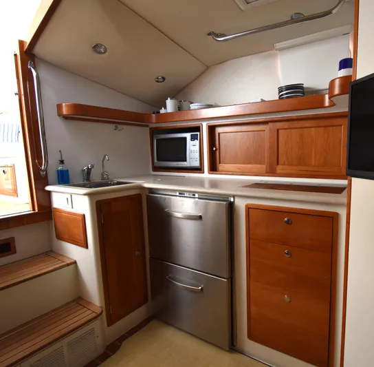 Delilah Yacht Photos Pics 2011 MJM 40z Downeast yacht kitchen with stainless steel appliances and wooden cabinets.