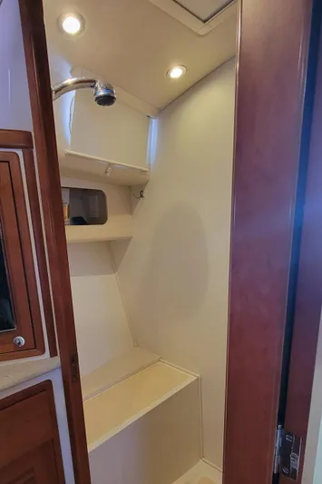 Delilah Yacht Photos Pics 2011 MJM 40z Downeast boat interior shower with wooden accents and built-in shelving.
