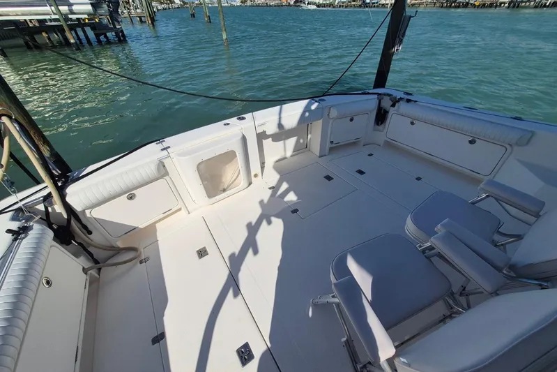  Yacht Photos Pics 2004 Riviera 4000 Offshore boat deck with seating, docked by the water.