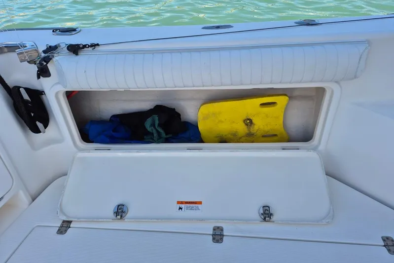  Yacht Photos Pics Storage compartment on a 2004 Riviera 4000 Offshore boat with gear and a yellow float.