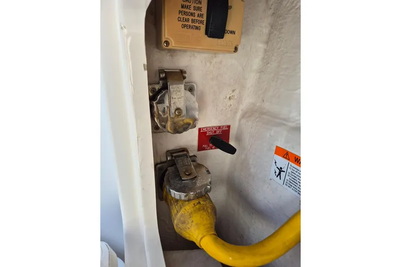  Yacht Photos Pics 2004 Riviera 4000 Offshore boat electrical panel with yellow cable and emergency fuel shut-off.