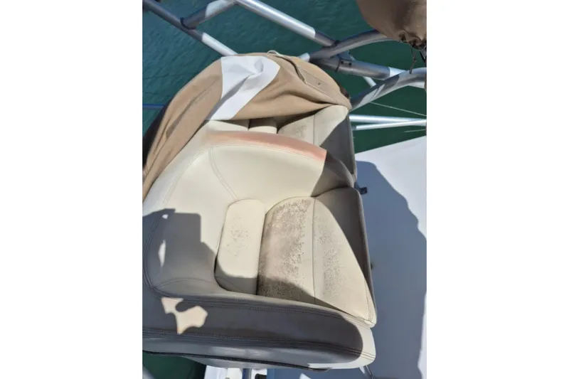  Yacht Photos Pics Worn seat on 2004 Riviera 4000 Offshore boat, showing signs of use and exposure.