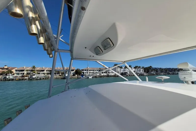  Yacht Photos Pics 2004 Riviera 4000 Offshore yacht with coastal view and clear blue sky.