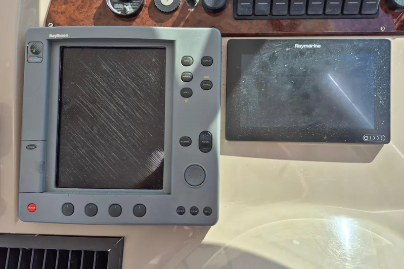  Yacht Photos Pics Control panel of a 2004 Riviera 4000 Offshore with Raytheon and Raymarine displays.