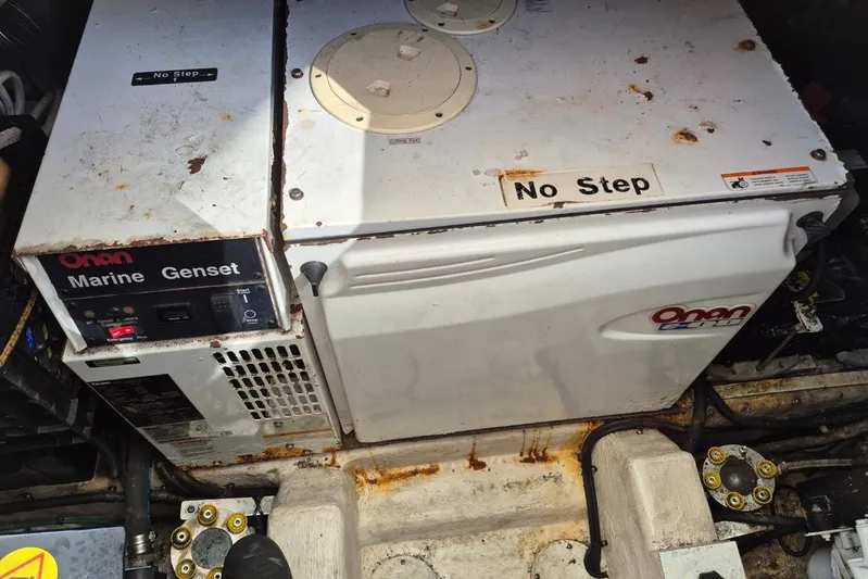  Yacht Photos Pics Onan marine generator in a 2004 Riviera 4000 Offshore engine room, labeled "No Step."