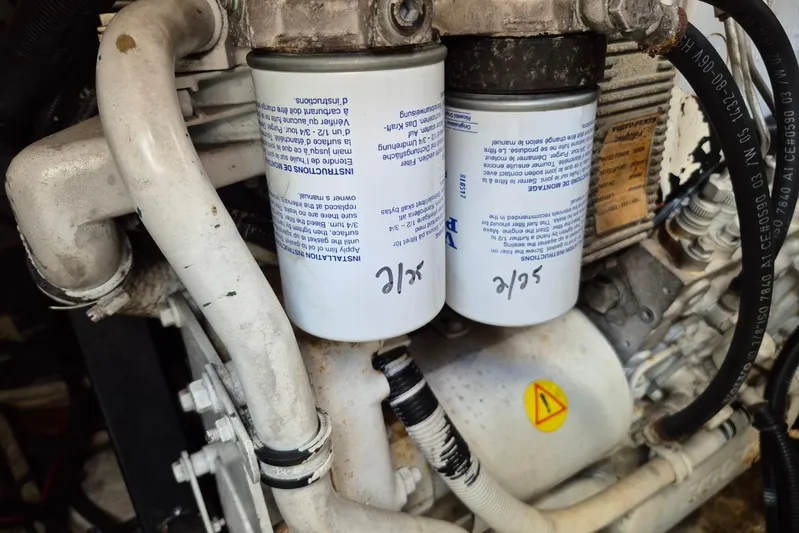  Yacht Photos Pics Engine components of a 2004 Riviera 4000 Offshore, featuring dual filters and labeled pipes.