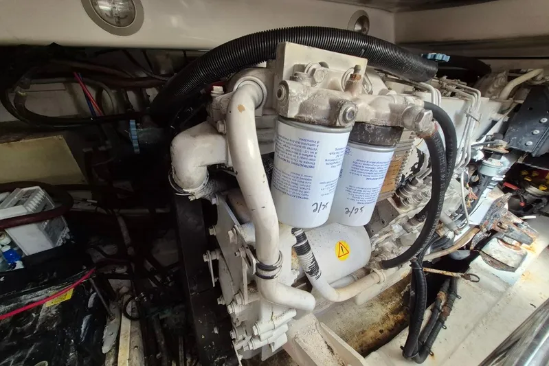  Yacht Photos Pics Engine compartment of a 2004 Riviera 4000 Offshore boat, showcasing filters and wiring.