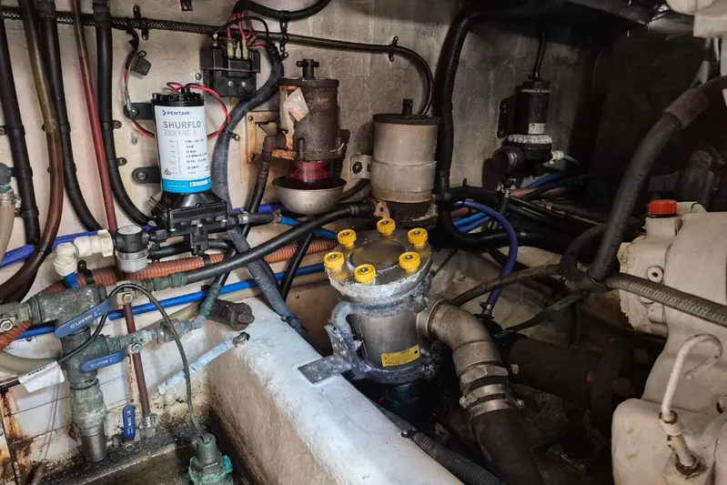  Yacht Photos Pics Engine room of a 2004 Riviera 4000 Offshore with visible mechanical components and wiring.