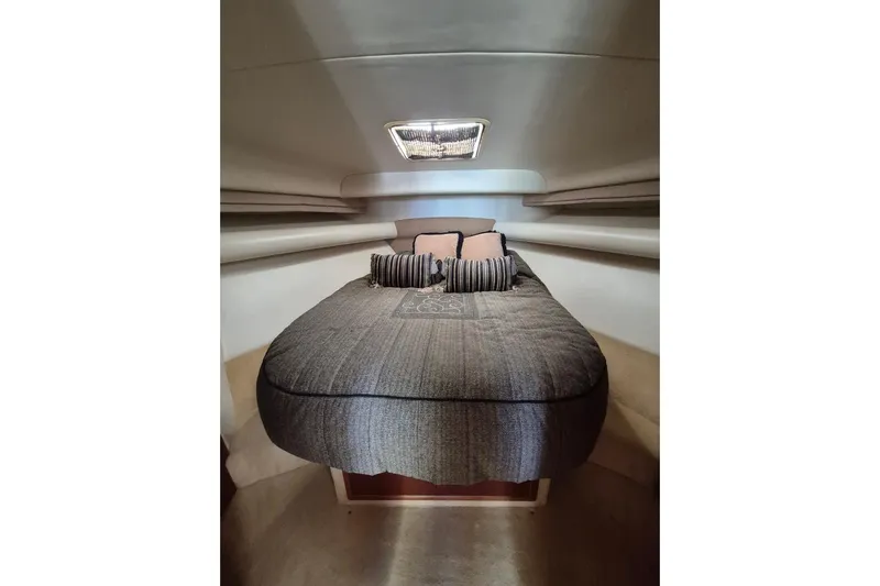  Yacht Photos Pics 2004 Riviera 4000 Offshore cabin interior with cozy bed and pillows.