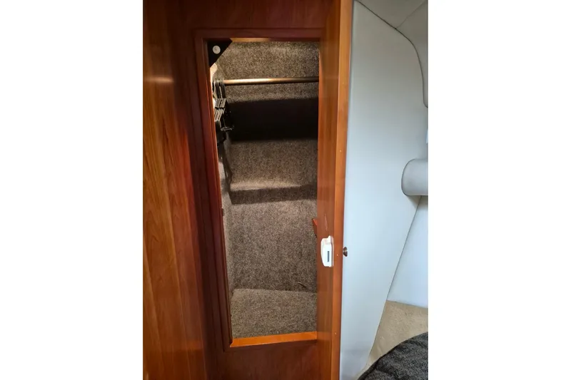  Yacht Photos Pics Interior view of 2004 Riviera 4000 Offshore boat closet with wooden door.