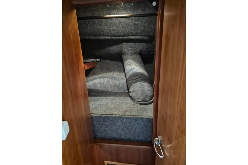  Yacht Photos Pics Interior cabin of 2004 Riviera 4000 Offshore yacht with wooden finish and cozy bedding.