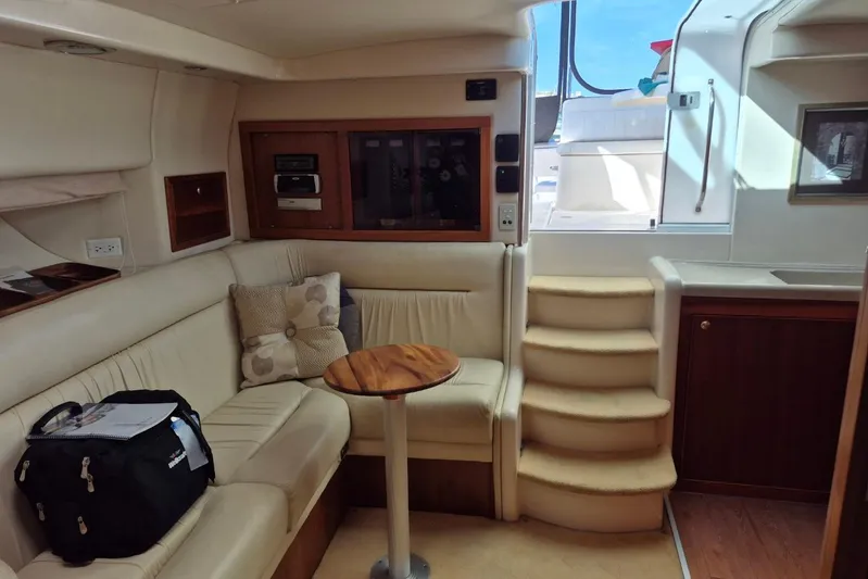  Yacht Photos Pics Interior of 2004 Riviera 4000 Offshore yacht with beige seating and wooden accents.