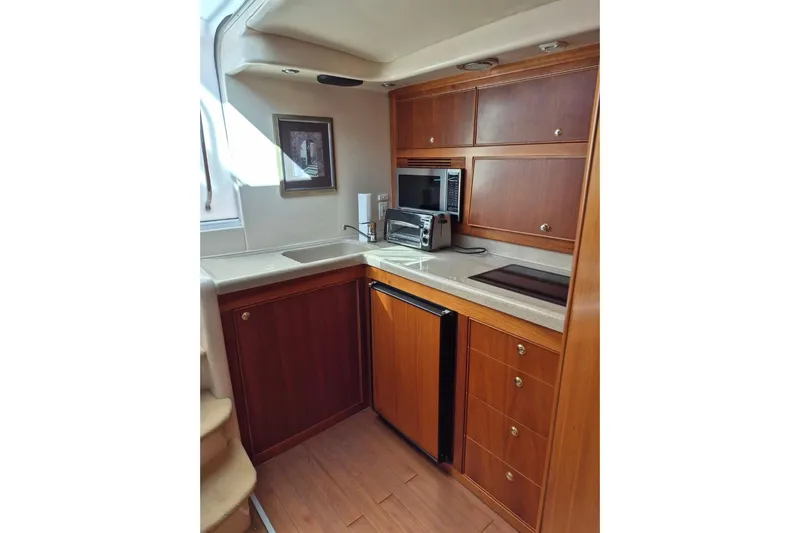  Yacht Photos Pics 2004 Riviera 4000 Offshore yacht kitchen with wood cabinetry and modern appliances.
