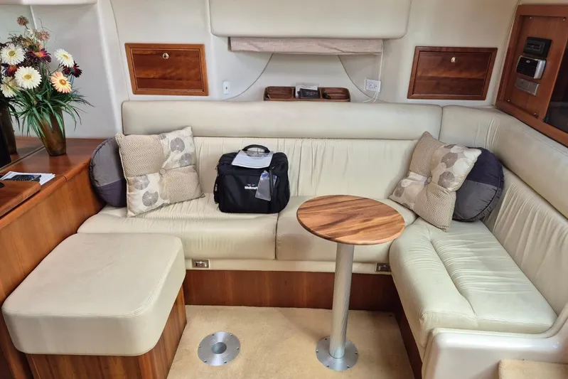  Yacht Photos Pics Luxurious interior of 2004 Riviera 4000 Offshore yacht with plush seating and wooden accents.