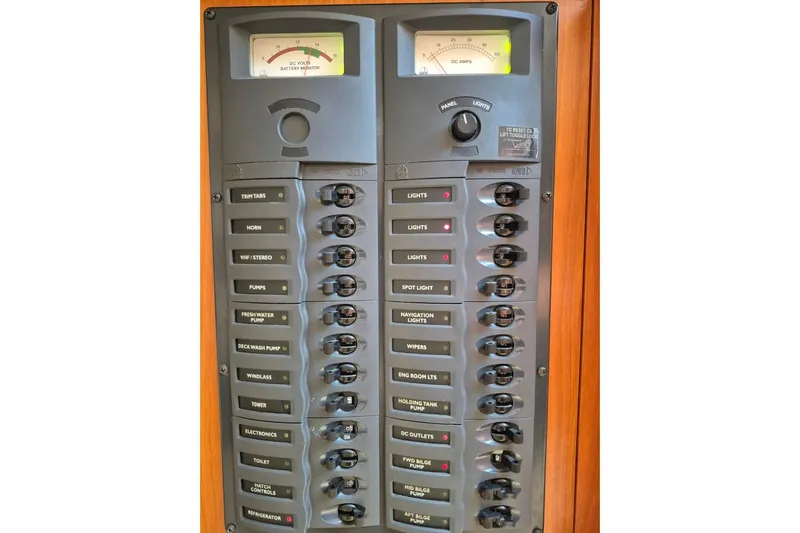  Yacht Photos Pics Electrical control panel on a 2004 Riviera 4000 Offshore boat, featuring various switches and gauges.