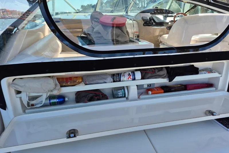  Yacht Photos Pics Storage compartment on a 2004 Riviera 4000 Offshore boat, containing various items and supplies.