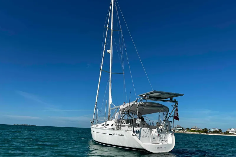 Monlove Yacht Photos Pics Sailing yacht Beneteau 393, 2007 model, anchored in clear blue waters under a sunny sky.