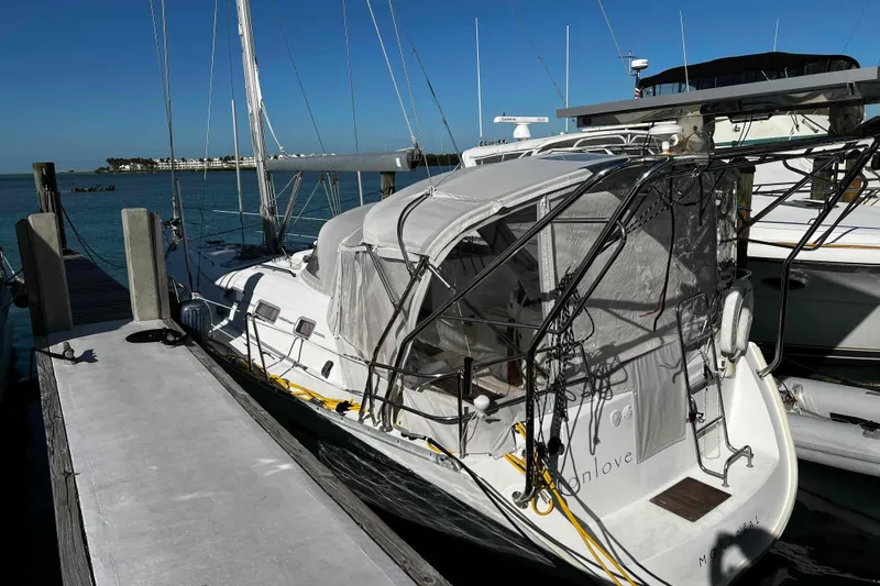 Monlove Yacht Photos Pics 2007 Beneteau 393 sailboat docked at marina, featuring covered cockpit and clear skies.