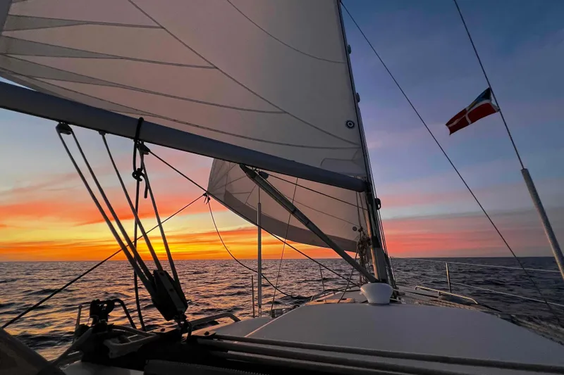 Monlove Yacht Photos Pics Sailing at sunset on a 2007 Beneteau 393 yacht, vibrant sky and ocean view.